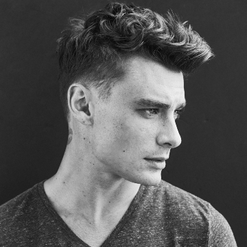 Black and white photos of man in gray t-shirt with clean cut hair longer and textured on top