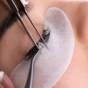 Professional applying eyelash extensions
