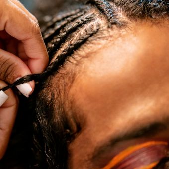 Woman braiding hair
