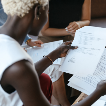 Woman reviewing documents at an office table